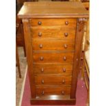 A Victorian walnut Wellington chest, having seven graduated drawers, turned knob handles and locking