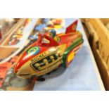 A tin plate friction drive Rocket Racer, comprising of red, yellow and green lithographed body