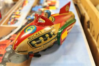 A tin plate friction drive Rocket Racer, comprising of red, yellow and green lithographed body