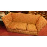 A red floral needlework upholstered three-seater Knoll sofa, having squab cushions, width 185cm Some