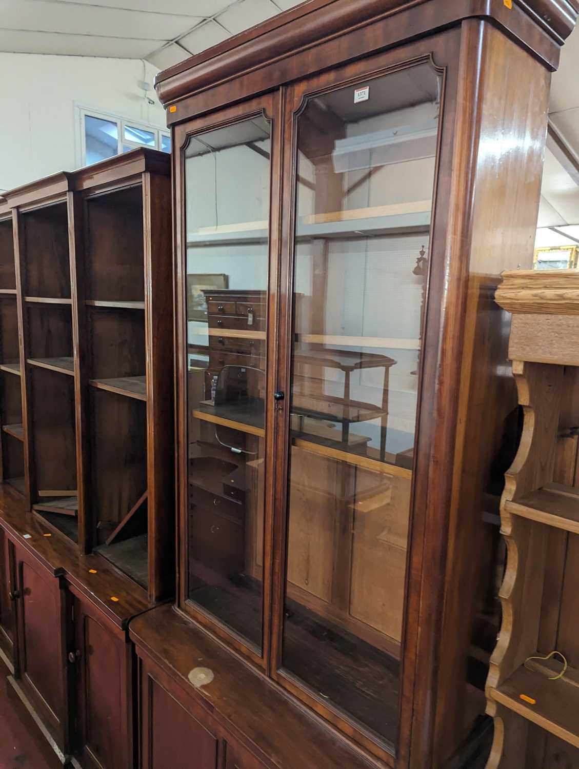 A mid-Victorian narrow mahogany round cornered bookcase cupboard, having twin glazed upper doors - Image 2 of 4