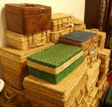 A large collection of various sized wicker travelling picnic baskets and hampers etc