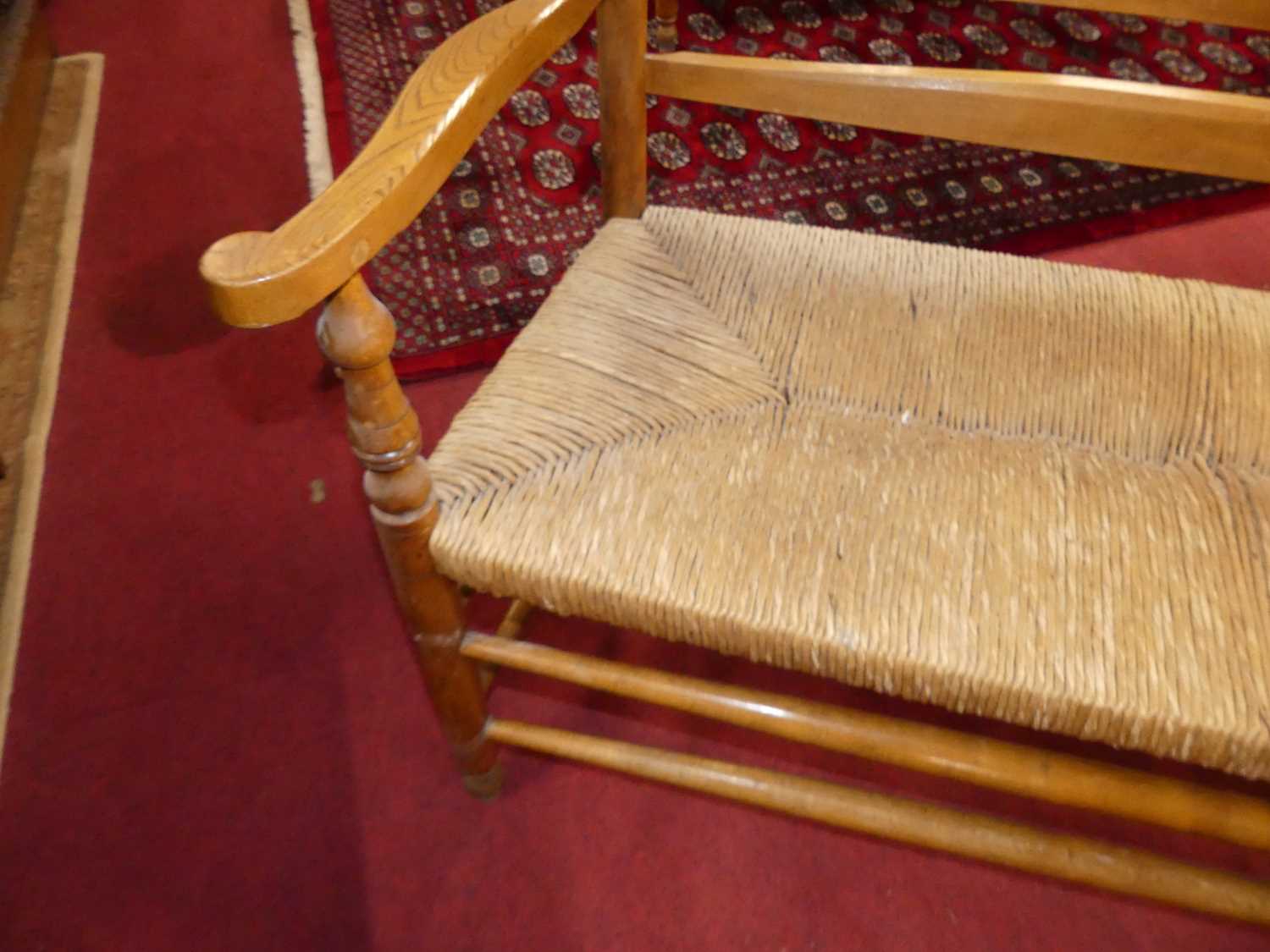 A set of four early 20th century elm and beech ladder back and rush seated two-seater settles, - Image 10 of 13
