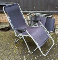 A pair of tubular metal and canvas folding garden lounge chairs, together with one other (3)