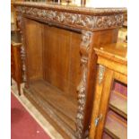 A circa 1900 heavily carved oak freestanding open bookshelf, having three adjustable shelves, the