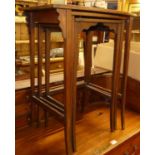 An early 20th century mahogany and chequer strung nest of three occasional tables, the largest w.