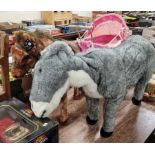 A soft plush horse with tack, together with a soft plush donkey, and a child's push-along baby