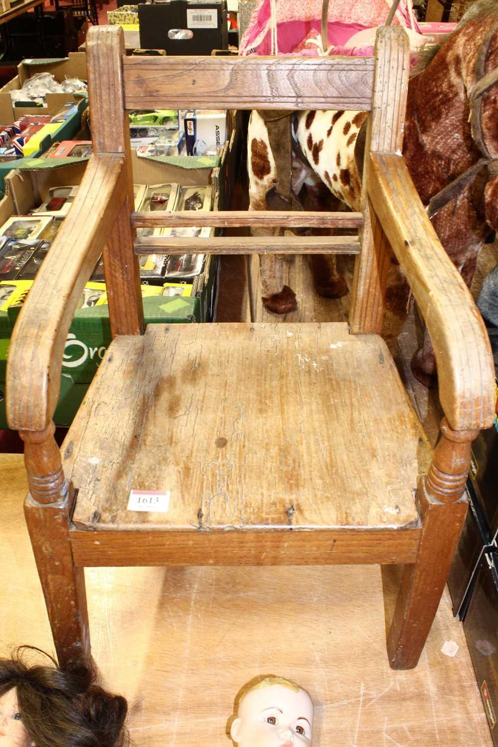 A provincial elm early 19th century child's panel seat elbow chair