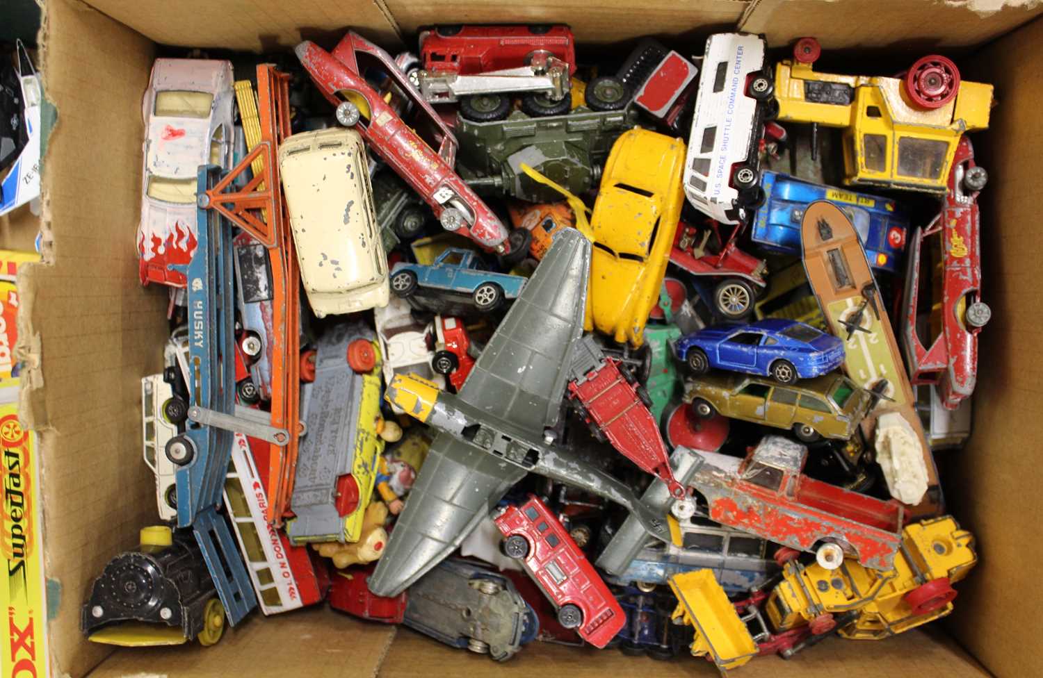 A box containing a quantity of playworn diecast vehicles to include Corgi Toys, Husky, Dinky etc