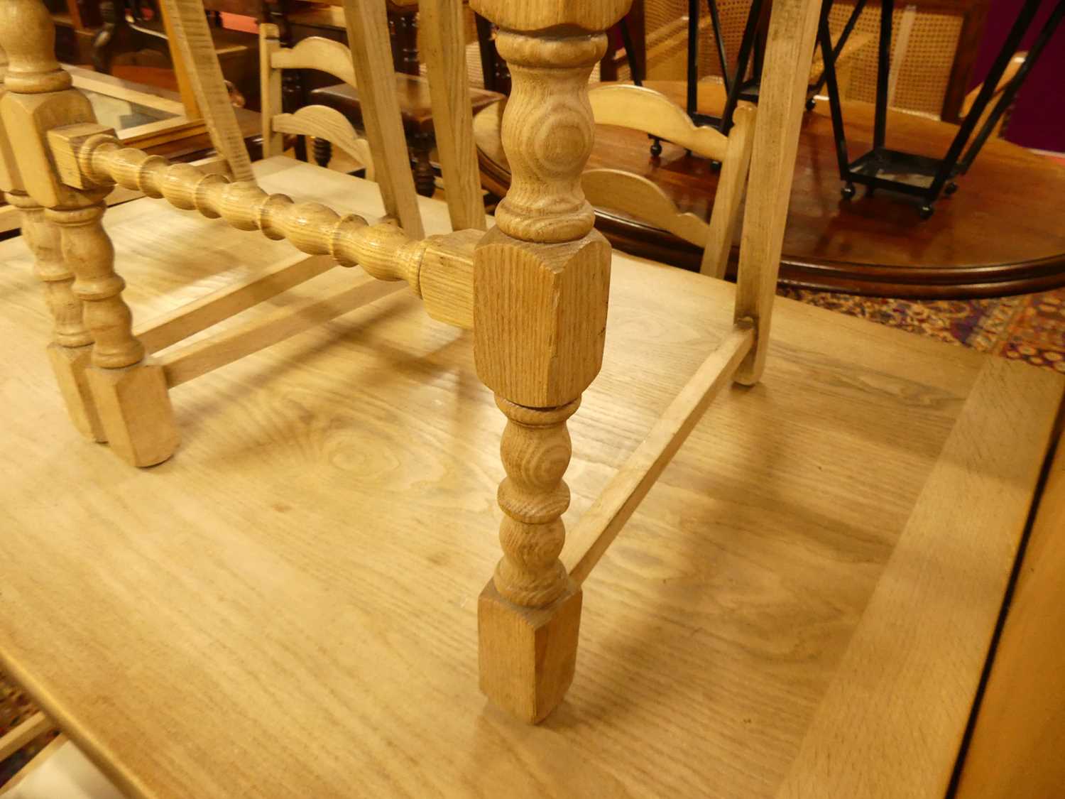 A 1930s limed oak dining suite, comprising; draw-leaf dining table, enclosed length 122cm, and a - Image 3 of 5