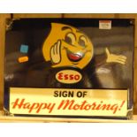 An enamel on metal wall mounted advertising sign titled ESSO Sign of Happy Motoring!, 26.5 x 34.5cm