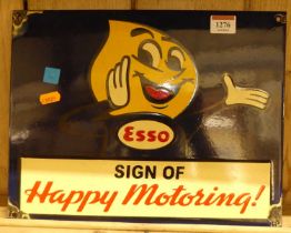 An enamel on metal wall mounted advertising sign titled ESSO Sign of Happy Motoring!, 26.5 x 34.5cm