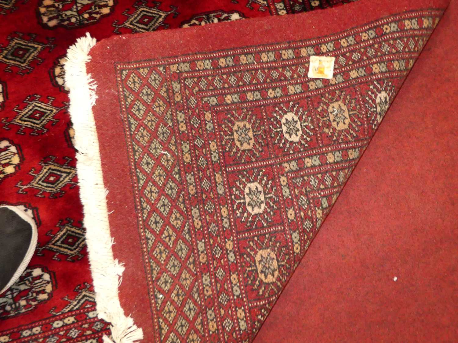 A Persian woollen red ground Bokhara rug, 242 x 154cm Rug is in excellent condition. Colours are - Image 4 of 4