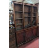 A Victorian mahogany breakfront bookcase, the three-division upper tier with open adjustable