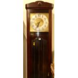 A 1920s stained beechwood longcase clock, having painted metal square Arabic dial, three train