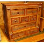 A South-East Asian stained softwood table-top chest, fitted with eight various drawers, w.37cm