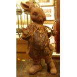 A contemporary cast iron garden ornamental figure of a standing rabbit holding a pipe, h.45cm