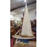 A very well made 1960s wooden hull pond yacht, hand painted in white with stained wooden deck,