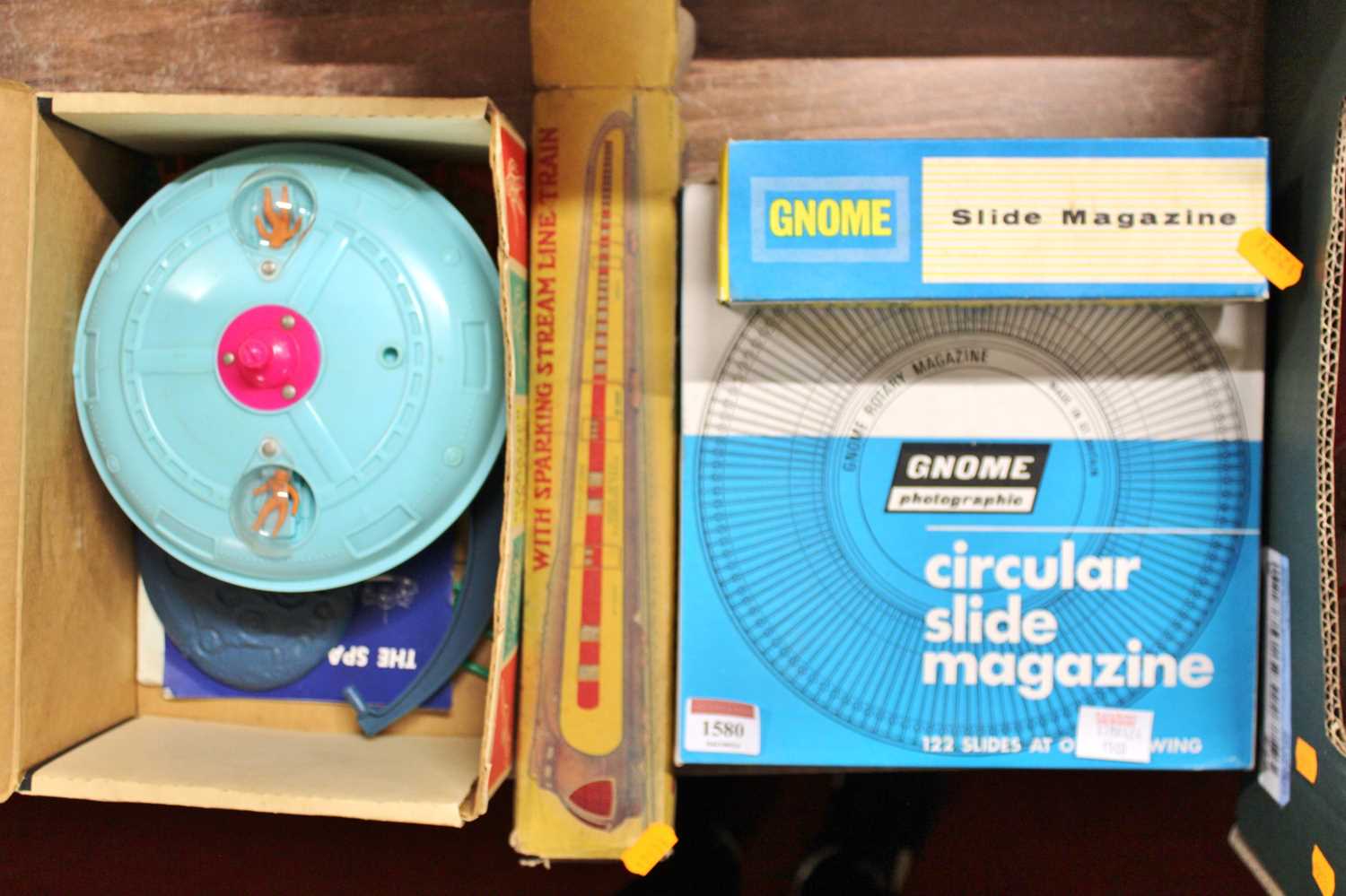 A gnome photograph circular slide magazine with a quantity of additonal slide indexes and a tin