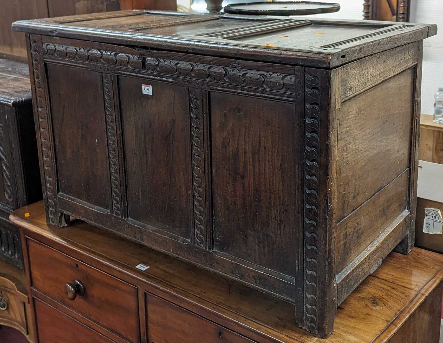 An 18th century joined oak three-panelled hinge topped coffer, with later chip-carved detail, w.99cm