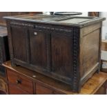 An 18th century joined oak three-panelled hinge topped coffer, with later chip-carved detail, w.99cm