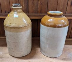 Two glazed stoneware storage jars, the larger h.44cm