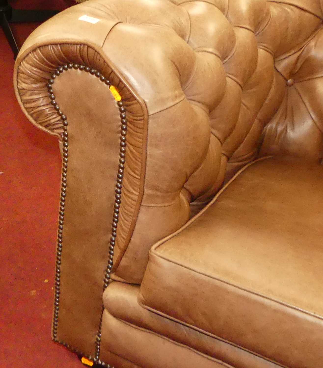 A contemporary tan leather buttoned upholstered three-seater Chesterfield, having squab cushions, - Image 2 of 4