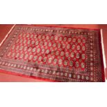 A Persian woollen red ground Bokhara rug, 242 x 154cm Rug is in excellent condition. Colours are