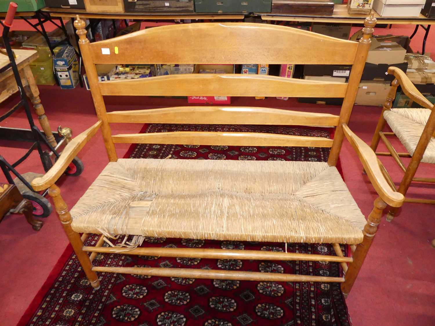 A set of four early 20th century elm and beech ladder back and rush seated two-seater settles, - Image 12 of 13