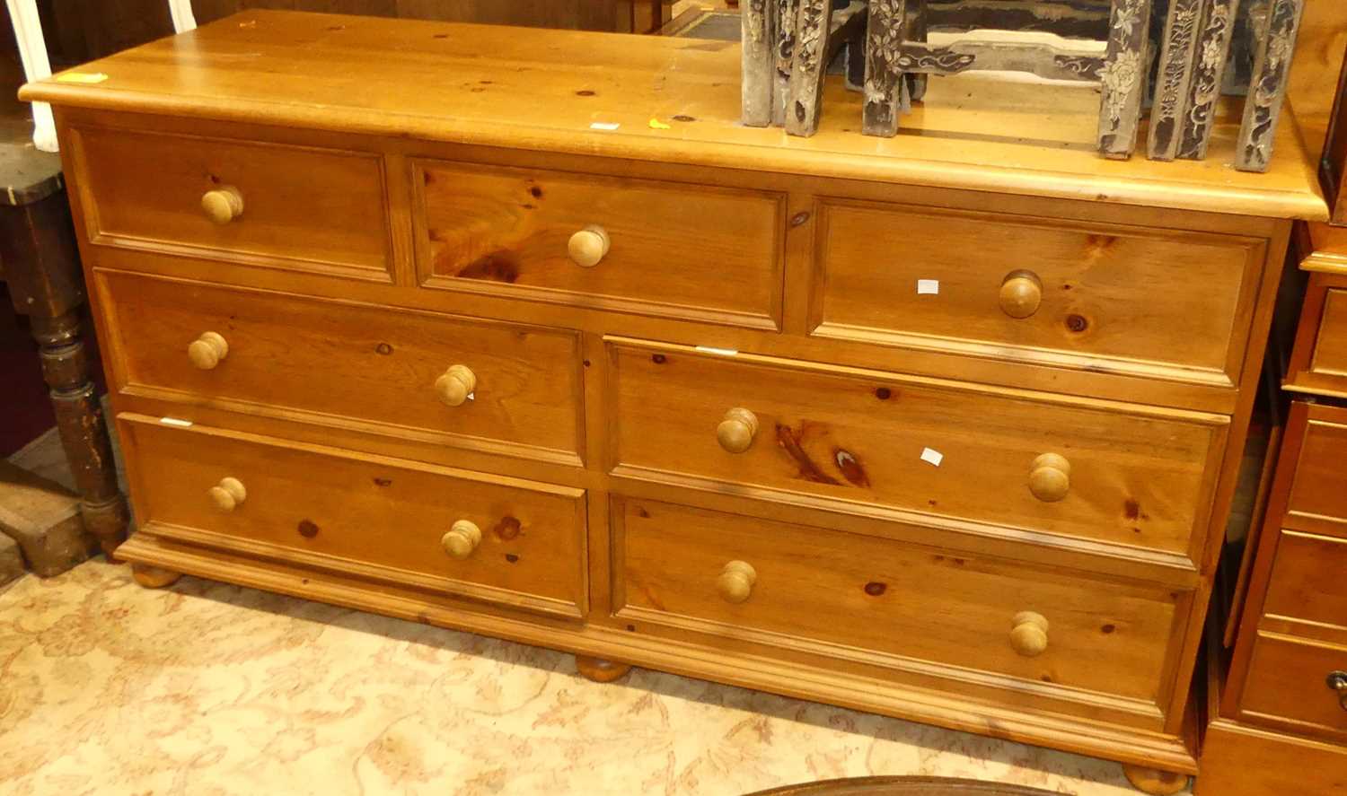 A modern pine long side chest, fitted with an arrangement of seven various drawers, w.166cm