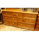 A modern pine long side chest, fitted with an arrangement of seven various drawers, w.166cm