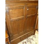 An antique joined oak double door panelled side cupboard, w.128cm