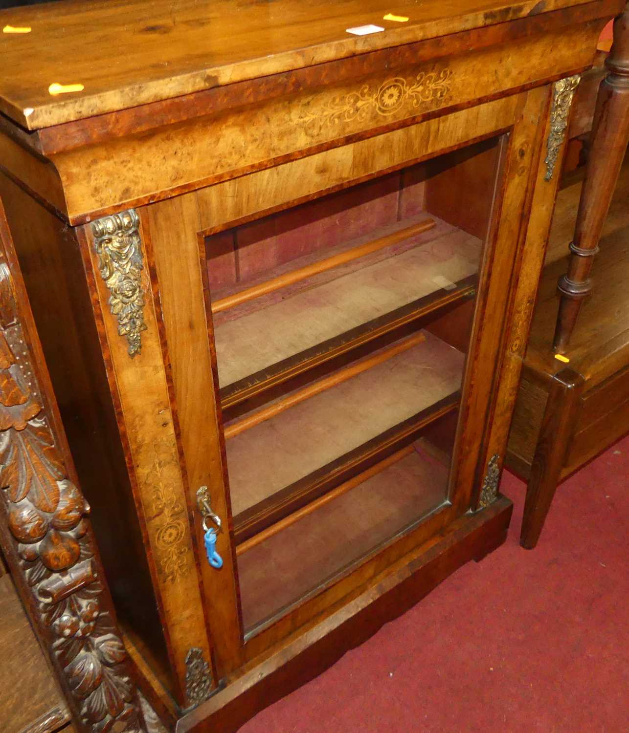 A Victorian figured walnut, gilt metal mounted and floral satinwood inlaid single door glazed pier