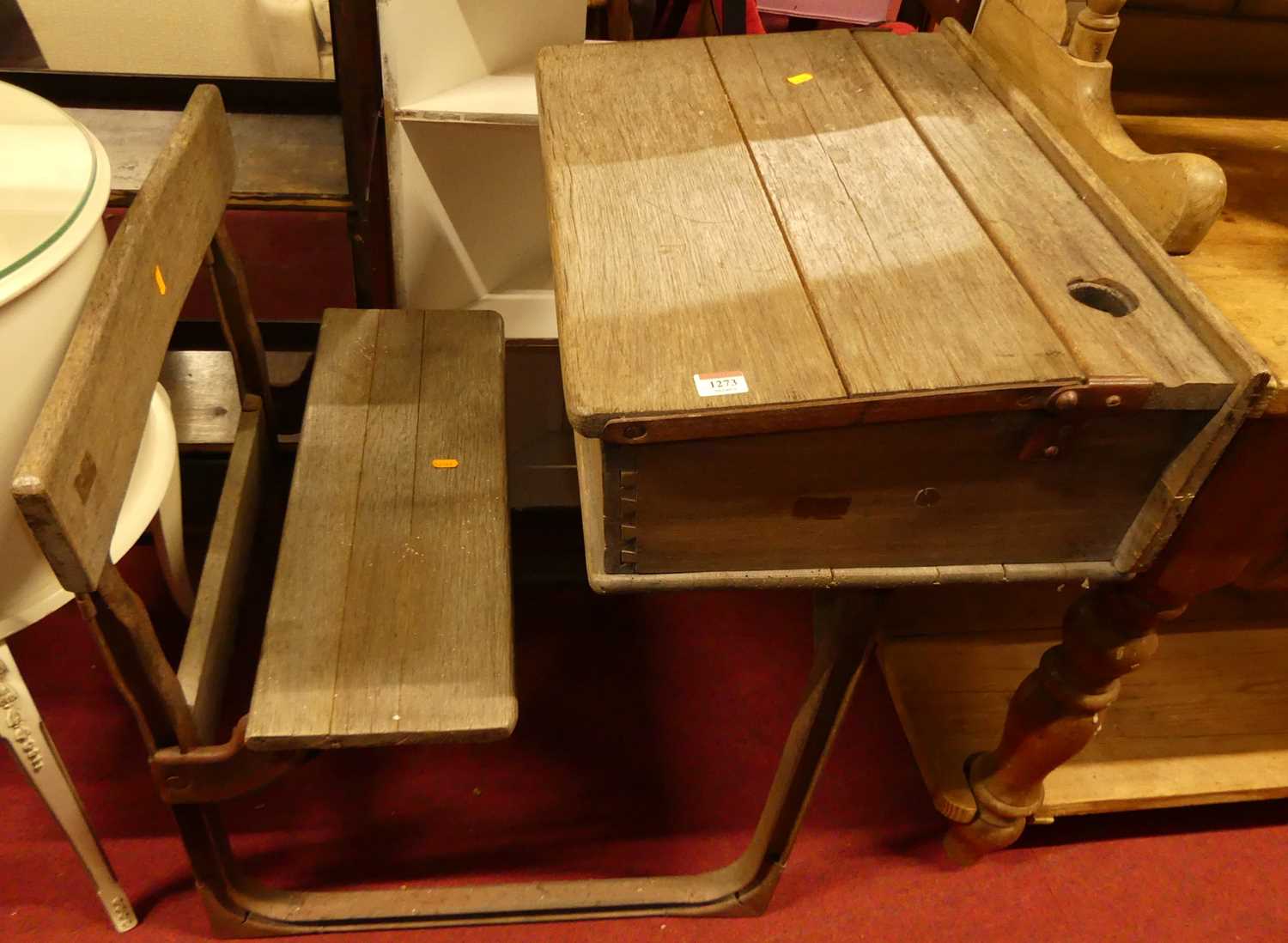 An early 20th century limed oak child's combination school table / seat, metal framed, with sloped