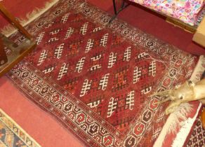 A collection of four various Persian woollen red and cream ground Bokhara rugs; together with a