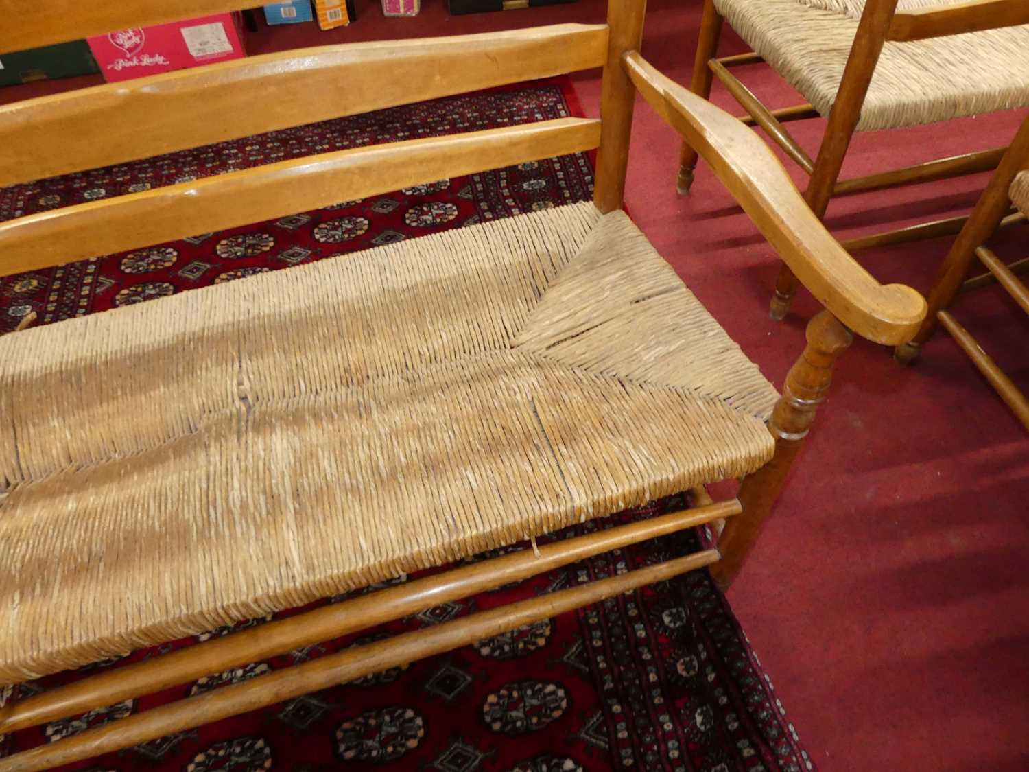 A set of four early 20th century elm and beech ladder back and rush seated two-seater settles, - Image 11 of 13