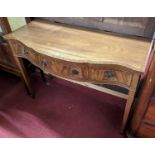 A contemporary mahogany and crossbanded serpentine front three drawer side table, raised on square