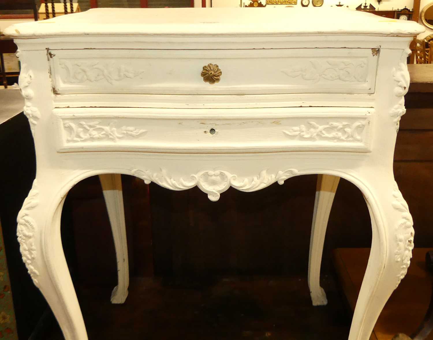 A French later white painted serpentine two drawer side table, raised on pronounced cabriole - Image 2 of 4