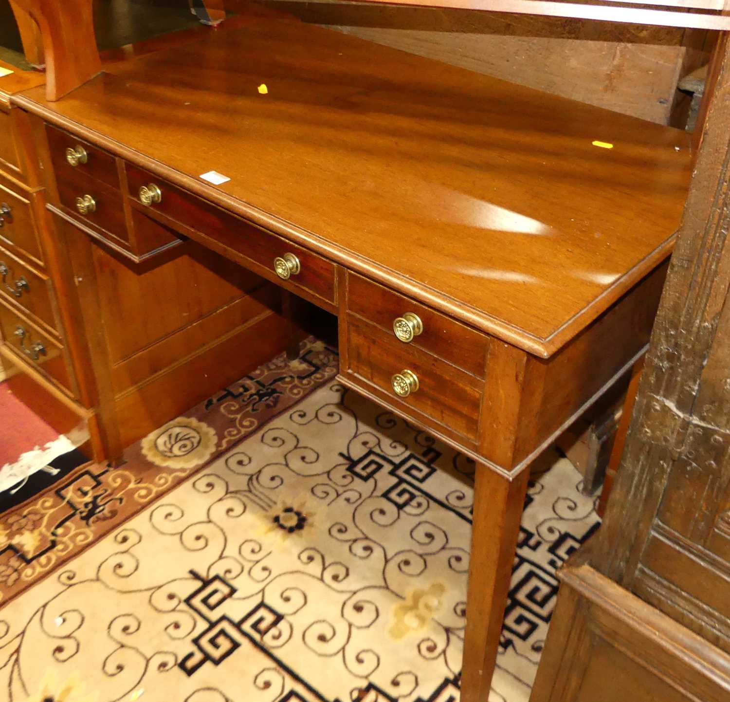 A circa 1900 mahogany kneehole dressing table, having an arrangement of four drawers, on square