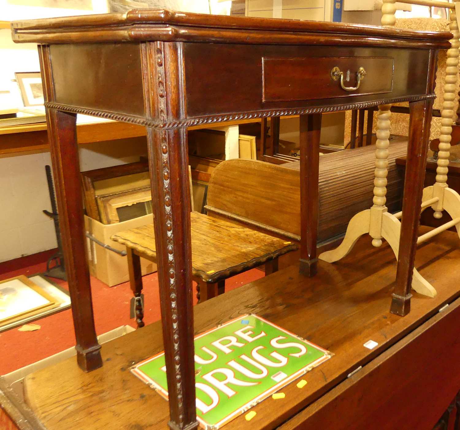 A George III mahogany serpentine front fold-over tea table, having rear gateleg action, single