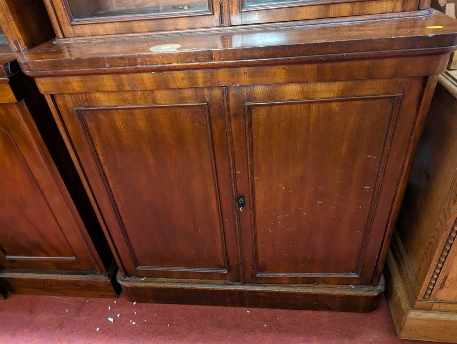 A mid-Victorian narrow mahogany round cornered bookcase cupboard, having twin glazed upper doors - Image 4 of 4