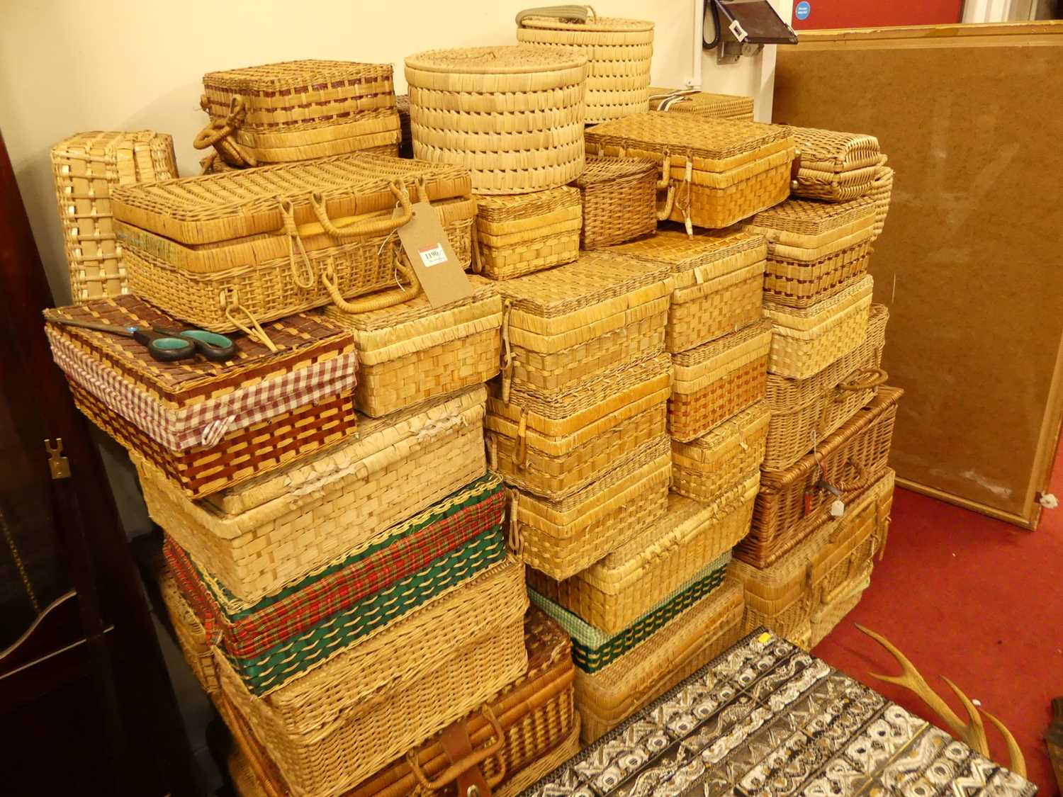 A large collection of various sized wicker travelling picnic baskets and hampers etc