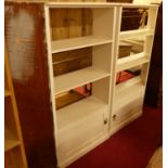 A pair of white painted corner bookshelves, each with a single lower cupboard door, w.79cm