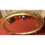A modern gilt framed oval wall mirror, 70cm, together with a framed oleograph, and two amateur