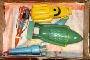 A vintage suitcase containing a quantity of plastic Made in Hong Kong Thunderbirds miniatures, to