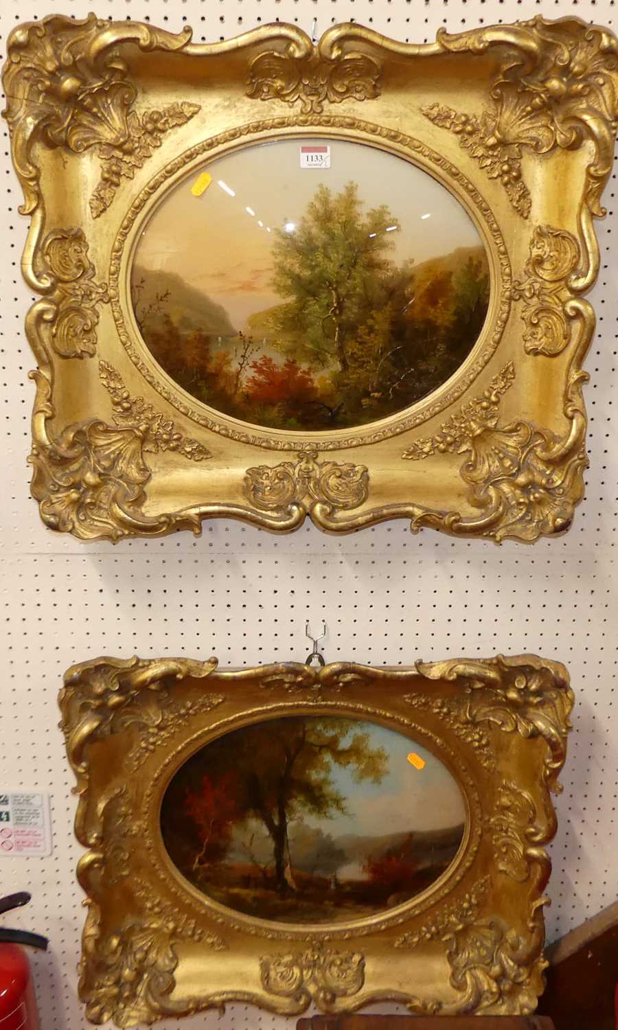 A pair of reverse oil paintings on glass of river landscape scenes, each framed as ovals, 32 x