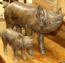 A contemporary metal model of a standing sow, length 55cm; together with a matching standing piglet,