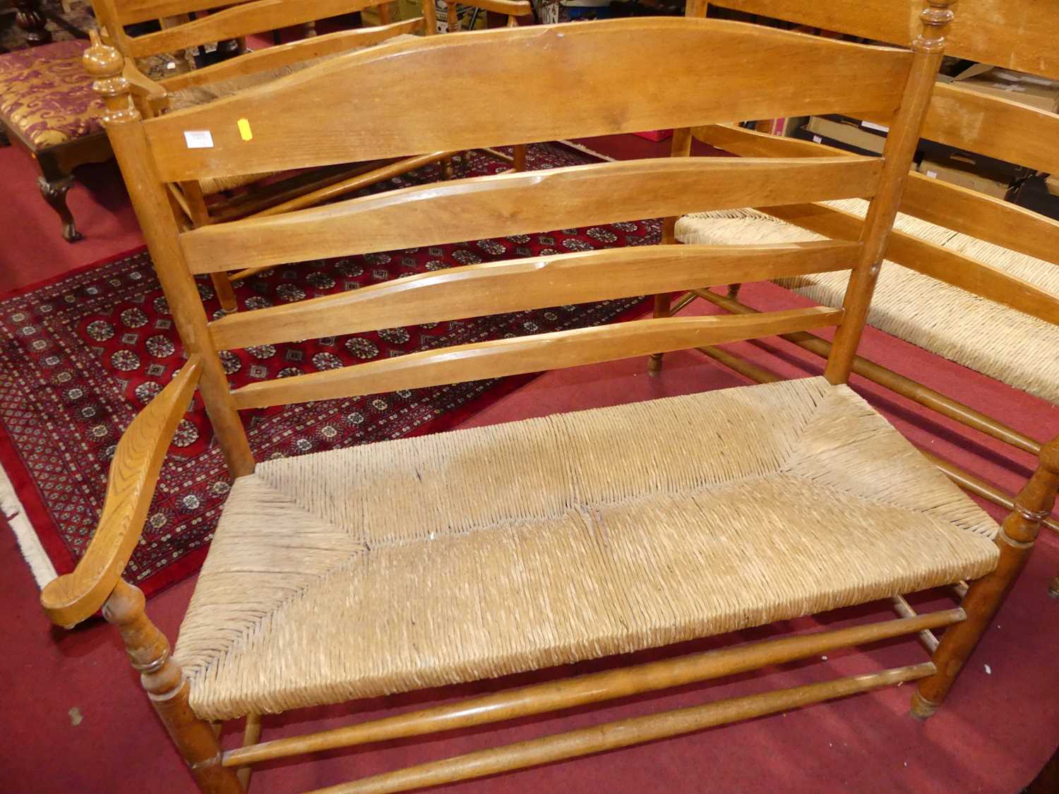 A set of four early 20th century elm and beech ladder back and rush seated two-seater settles, - Image 9 of 13