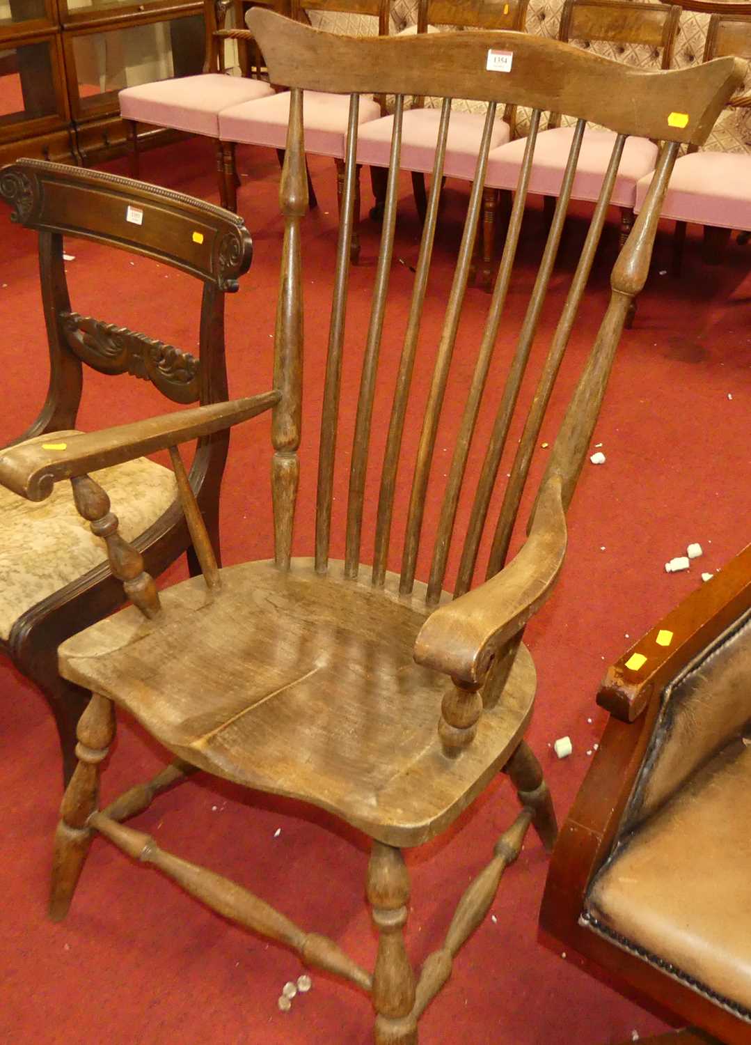 An early 20th century elm and beech stickback farmhouse open armchair, w.61cm