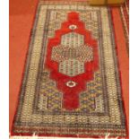 A Persian woollen red ground Bokhara rug, 200 x 98cm; together with a Persian woollen red ground